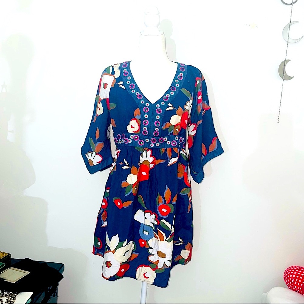 Neslay Paris baby doll dress with navy blue grind and fall colored flowers.